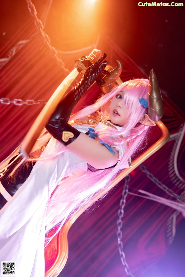 A woman in a white dress holding a sword.