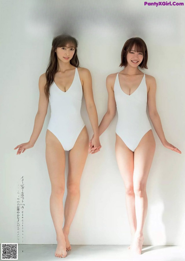 Two women in white swimsuits standing next to each other.