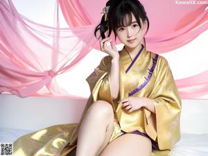 A woman in a white kimono sitting on a bed.