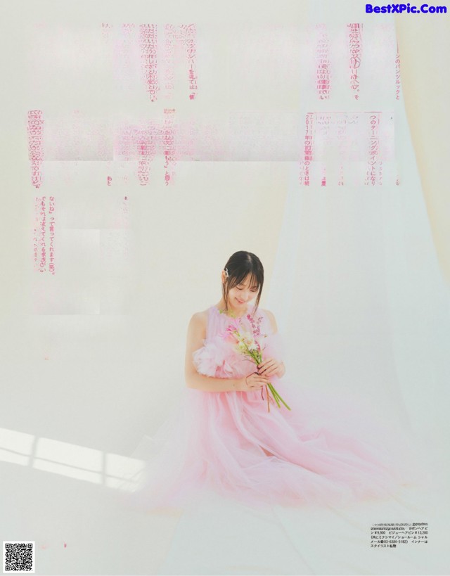 A woman in a pink dress holding a bouquet of flowers.