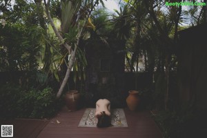 A naked woman standing in a swimming pool.