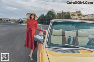 A woman in a white shirt is posing for a picture.