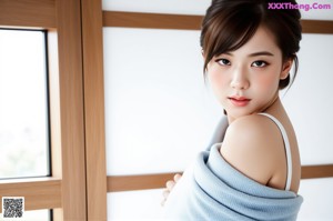 A woman in a green sweater and white shorts posing by the water.