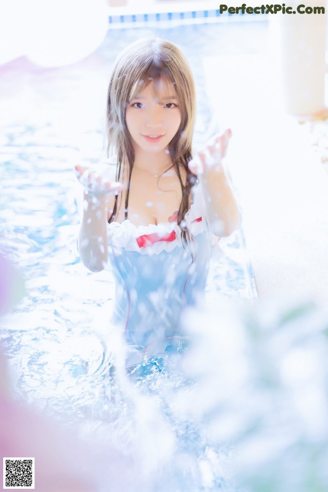 A woman in a blue and white bathing suit in a pool.