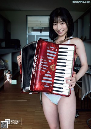 A woman in a white shirt is posing for the camera.