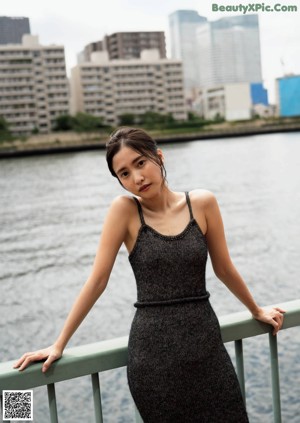 A woman in a white dress sitting on a bench.