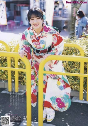 A group of young women in kimonos posing for a picture.