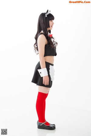 A woman in a black and white outfit and red tights.