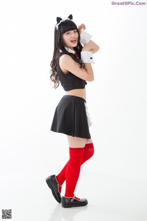 A woman in a black top and red stockings.