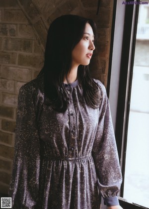 A woman with long black hair is posing for a picture.