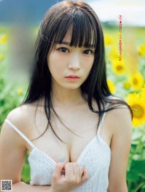 A woman in a white lingerie standing in front of an open refrigerator.