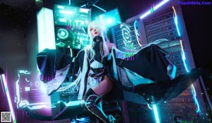 A woman with long white hair sitting in front of a neon sign.